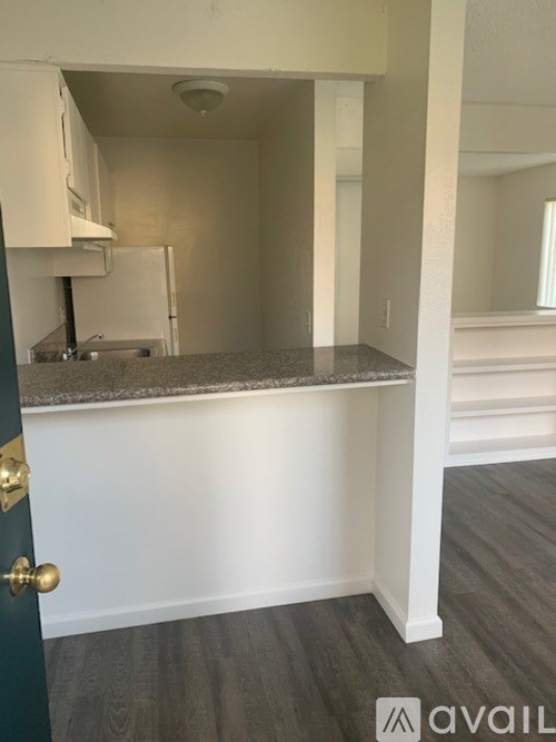 A kitchen area with a countertop and cabinets.