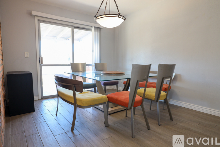 A dining room with a table and chairs.