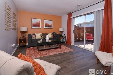 A living room with a grey couch and a coffee table.