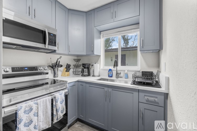 A kitchen with a stove, oven, and cabinets.