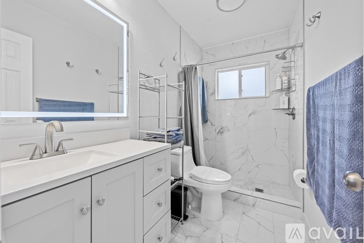 A room with a bunk bed and a ceiling fan.