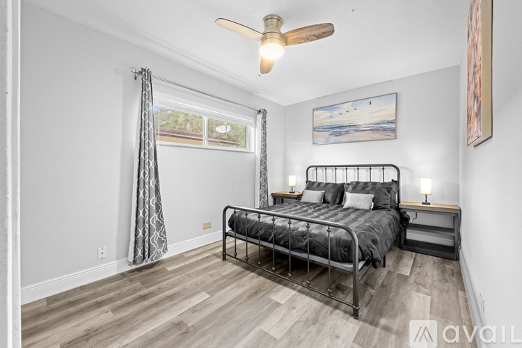 A bedroom with two bunk beds and a ceiling fan.