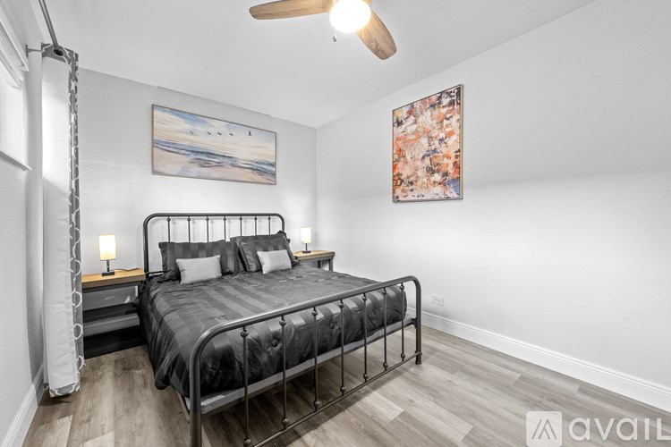 A bedroom with two beds and a window.