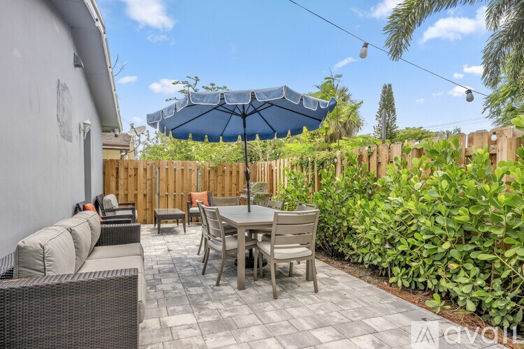 A white closet with a blue shirt hanging on a hanger.