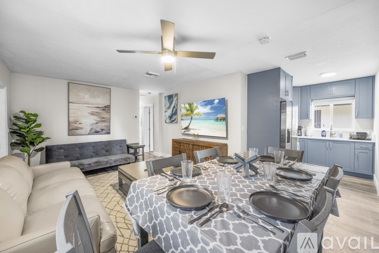 A modern dining room with a large table set for a meal.