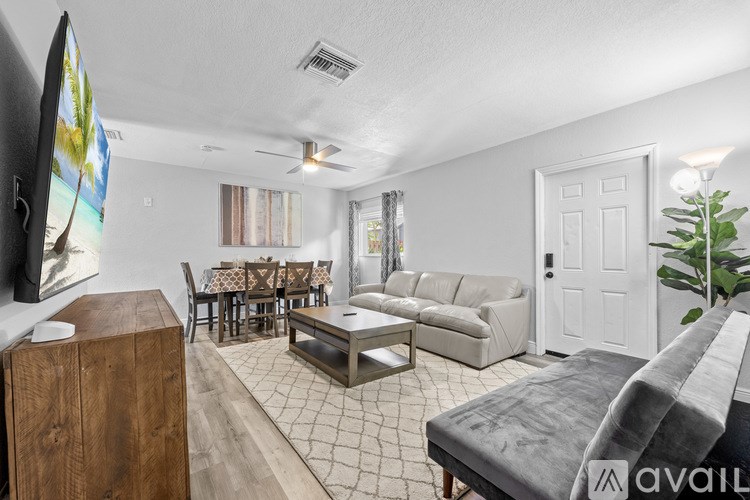 A dining room with a table set for a meal.