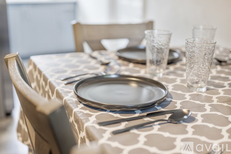 A table set with plates, glasses, and cutlery.