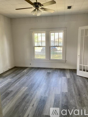 A room with a fan and a window.