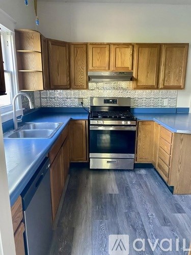 A kitchen with wooden cabinets and a stainless steel oven.