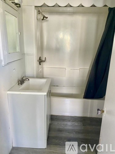 A white sink is on a white cabinet in a bathroom.