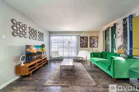 A living room with a green couch and a coffee table.