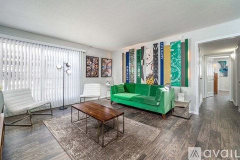 A living room with a green couch and a wooden coffee table.