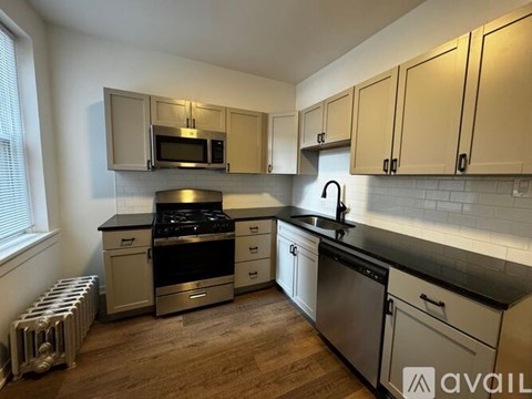 A kitchen with a stove, oven, and microwave.