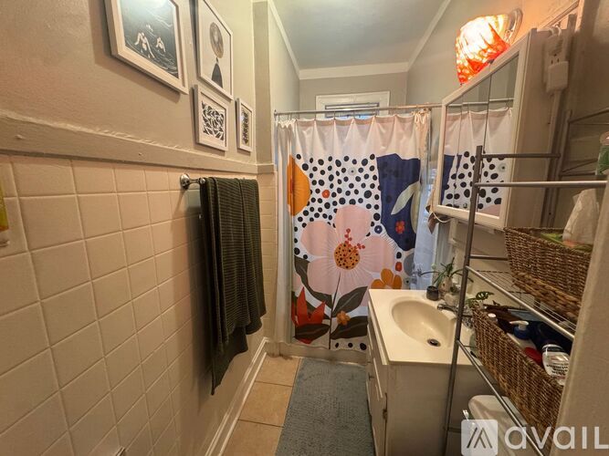 A room with wooden flooring and a window on the left side.