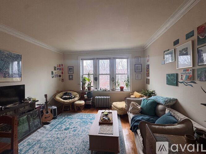 A room with wooden floors and a ceiling fan.