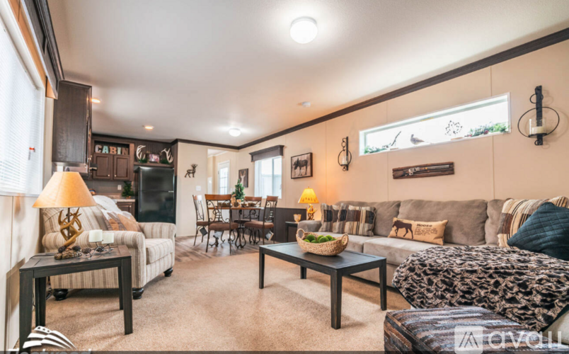 A living room with a sofa, a coffee table, and a dining table.