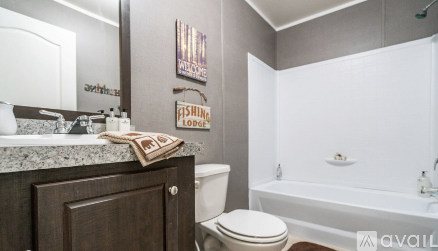 A bathroom with a toilet, sink, and bathtub.