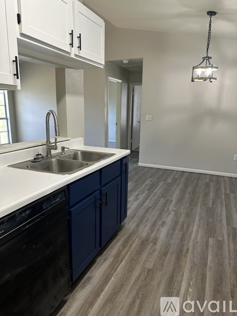 A kitchen with a sink and a dishwasher.