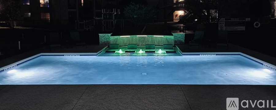 A pool with green lights in the middle of it.