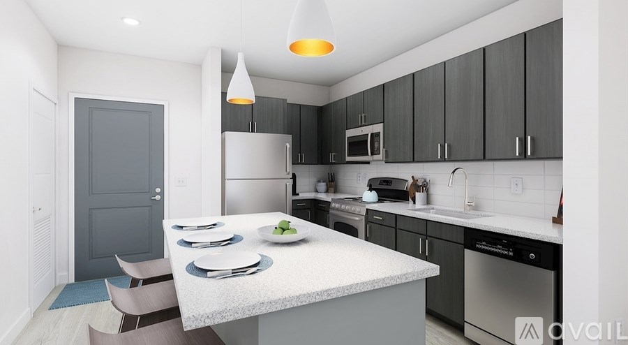A modern kitchen with a dining table set for two.