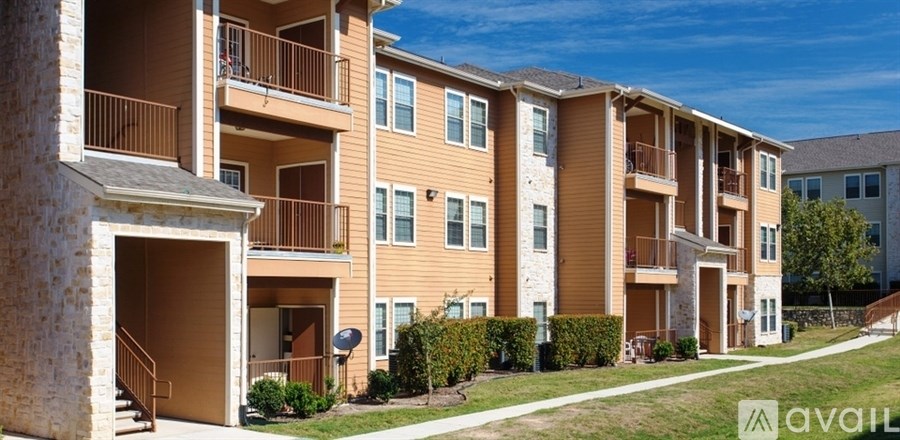 A row of apartment buildings with balconies and satellite dishes on the roofs.