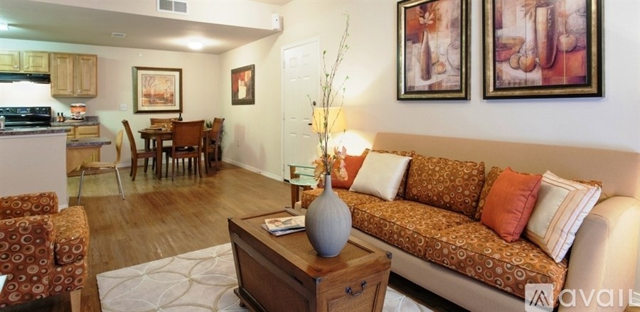 A living room with a couch, chairs, and a coffee table.