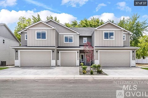 A house with a grey facade is for sale.