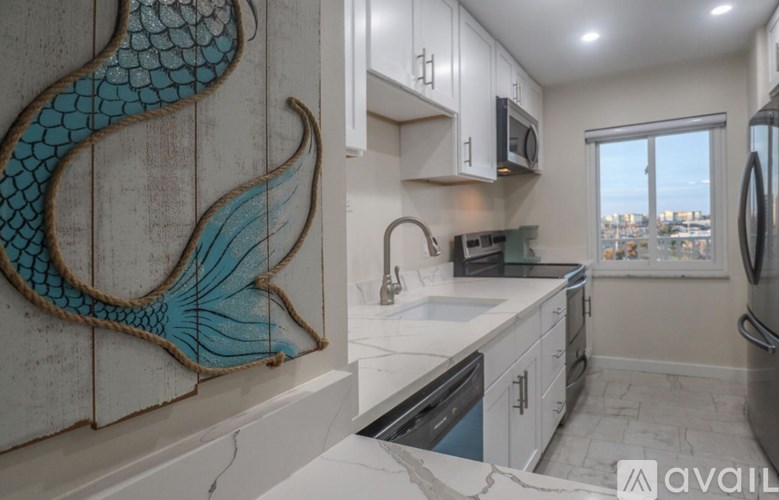 A kitchen with a fish decoration on the wall.