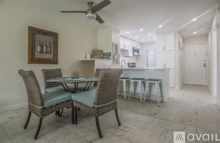 A dining area with a table and chairs.