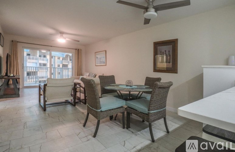 A living room with a dining table and chairs.