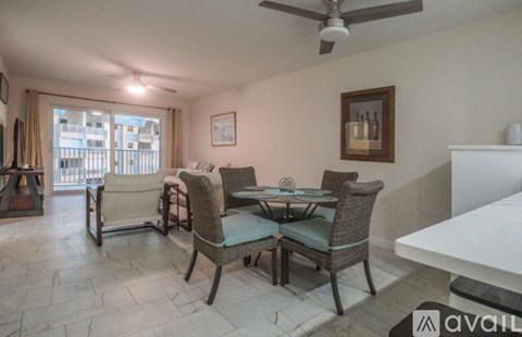 A living room with a dining table and chairs.