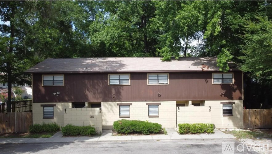 A brown building with a black fence in front of it.