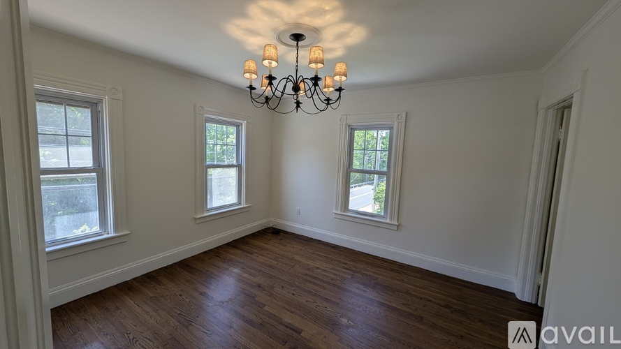 A room with wooden floors and a chandelier.