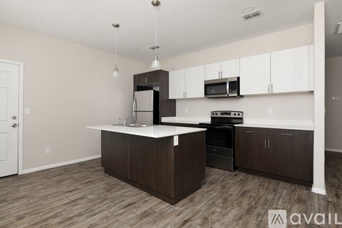 A kitchen with brown cabinets and a white island.