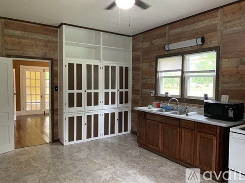 A kitchen with wooden cabinets and a white fridge.
