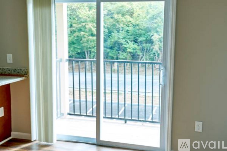 A view of a balcony through a sliding glass door.