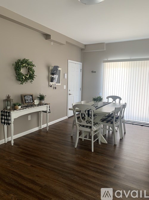 A dining room with a table and chairs.