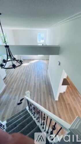 A staircase with a wooden floor and a metal railing.