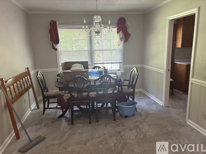 A dining room with a table set for six.