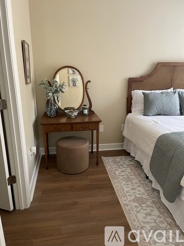 A bedroom with a bed, a dresser, and a mirror.