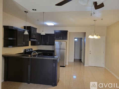 A kitchen with black cabinets and a countertop.