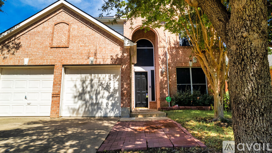 A house with a brick facade and a white garage door.