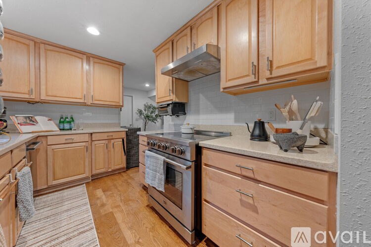 A kitchen with wooden cabinets and a stove top oven.