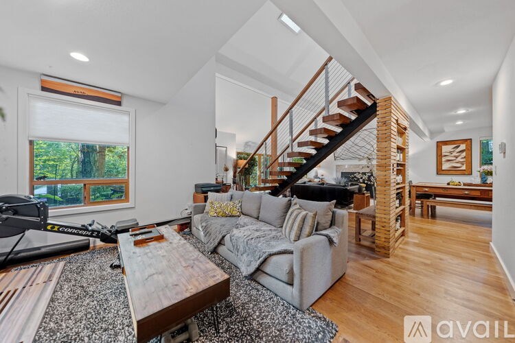 A living room with a grey couch and a wooden coffee table.