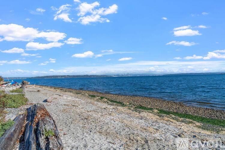 A beach with a clear blue sky and a few boats docked on the shore.