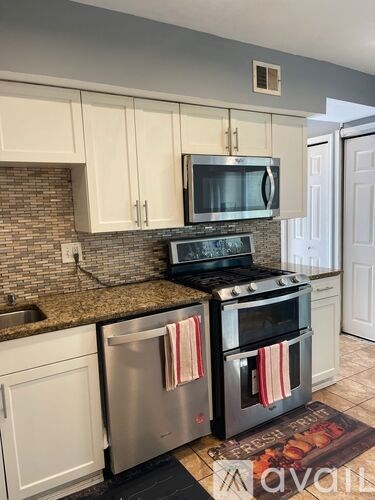 A kitchen with a stove top oven and microwave above it.