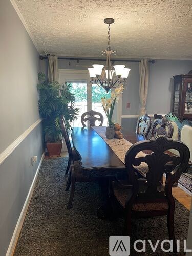 A dining room with a table and chairs.