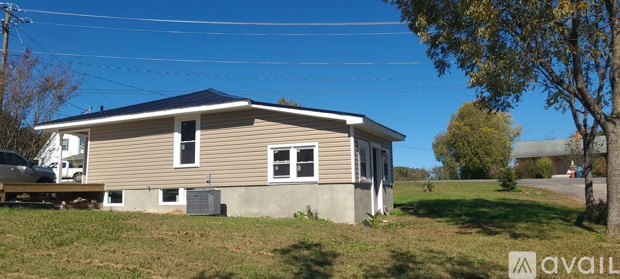 A house with a carport attached to it is for sale.