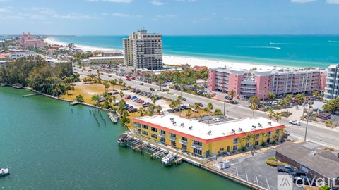A beachfront area with a pier and buildings.