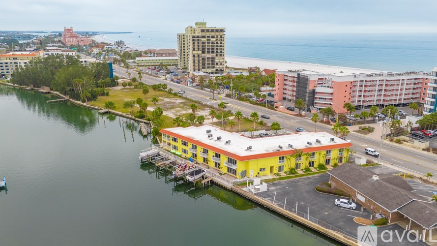 A yellow building sits on a dock by a body of water.